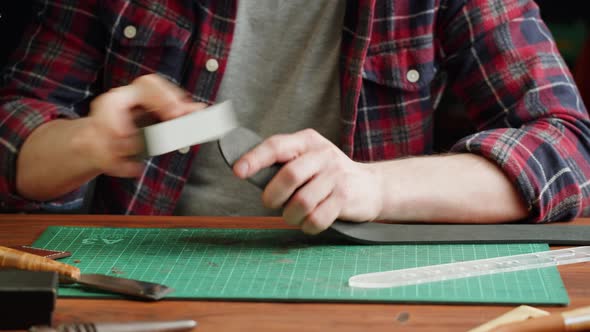 Man Tailor Polishing Artificial Leather Closeup alt