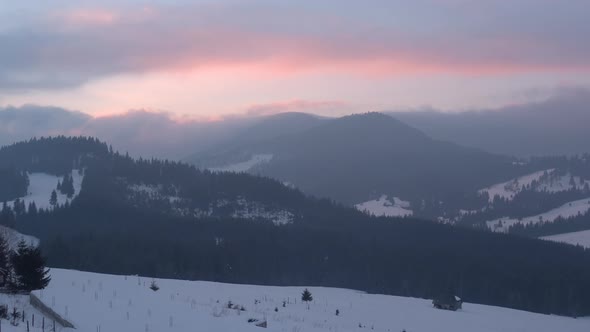 Aerial view of mountains during winter alt