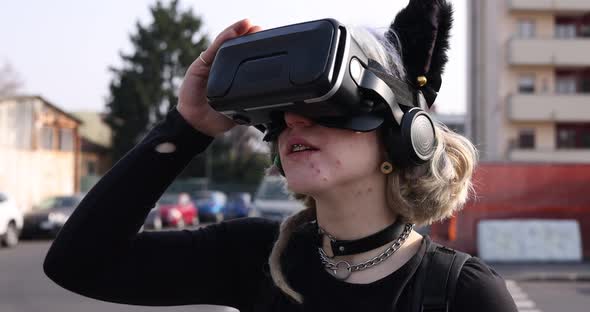 4k slow motion diverse young no makeup woman outdoor posing using 3d goggles enjoying metaverse alt