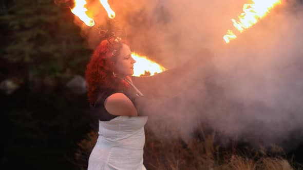 Woman Performing Fire Spinning with Smoke alt