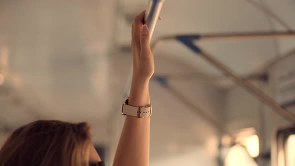 Woman Passenger Holding Handrail On Crowded Train Or Electric Train. Hand With Watch Taken Handrail alt
