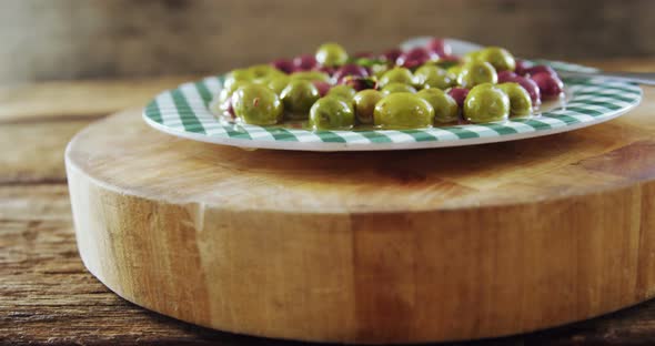 Plate of pickled olives and herbs alt