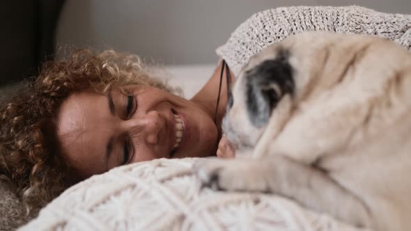 Woman play with dog at bed alt