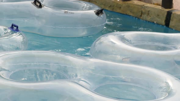 Close Up of White Transparent Floaters Moving with the Current in Lazy River alt