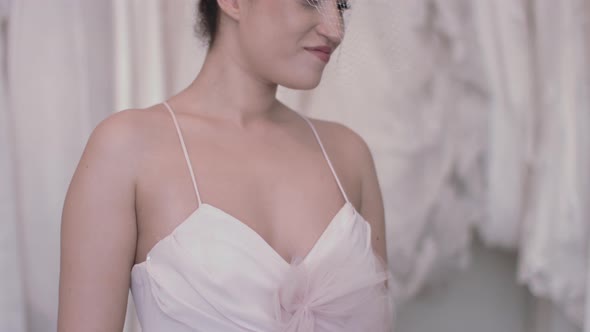 Young bride admiring herself in wedding dress