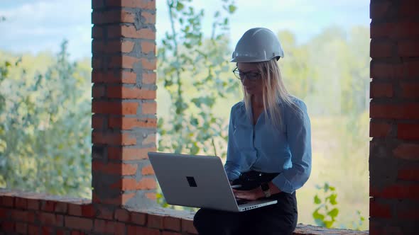 Designer On Construction Site.Engineer Inspecting Checking Building.Civil Architect With Blueprints alt