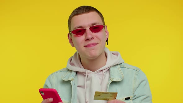 Teen Man Using Credit Bank Card and Smartphone While Transferring Money Purchases Online Shopping alt