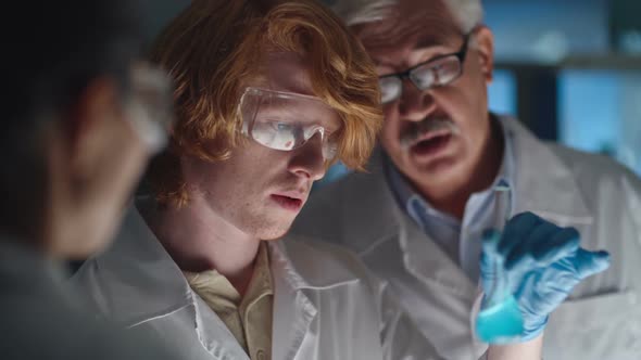 Chemistry Student Watching Chemical Reaction alt