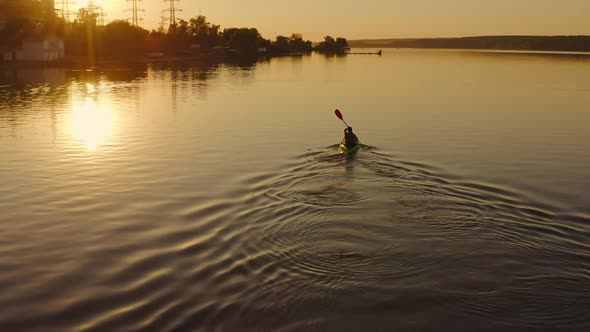 Man floating in boat on vacation. Swimming on kayak boat. Fitness workout with oars. alt