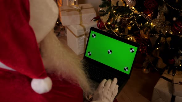 Modern Santa Claus Greets Talks Online Webcam Video Call Laptop Green Screen alt