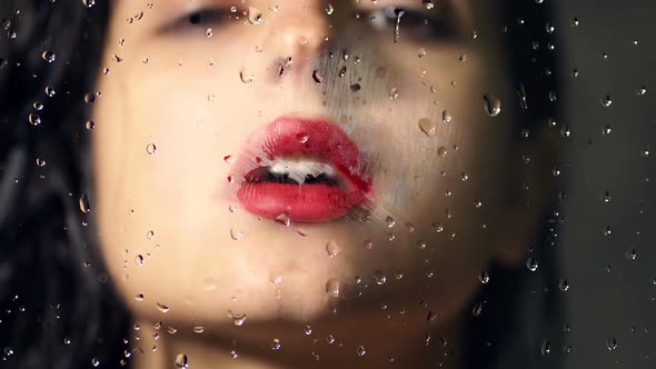 Portrait of Young Woman Kissing Glass with Water Drops