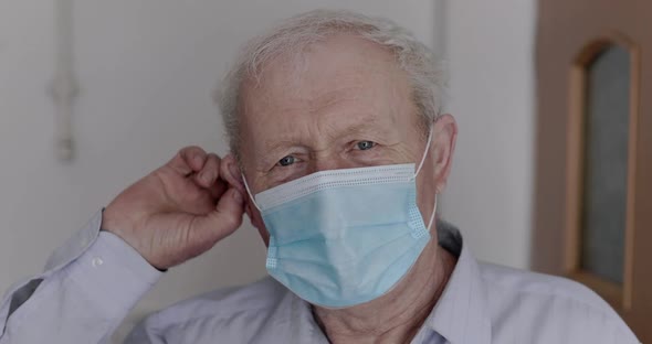 An Elderly, Cured Man Removes a Medical Mask and Genuinely Rejoices at Camera alt