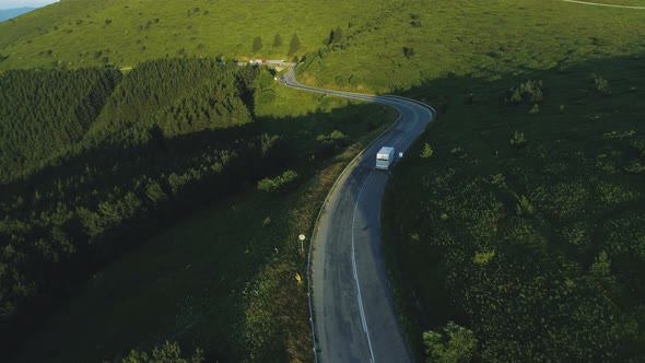 Drone Following White Cargo Van Driving in the Mountains in Summer alt