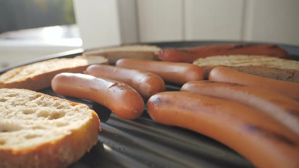 The Barbecue Grill with the Frankfurter and Toast Bread on Top alt