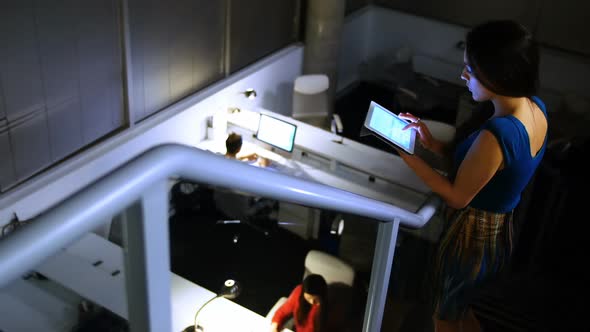 Female executive using digital tablet alt