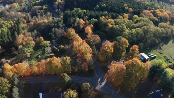Aerial Drone Shot Flying Over Farm and Tilting Up to Reveal Fall Sunset