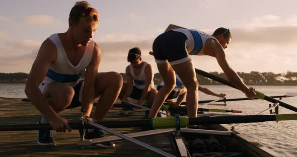 Male rower team preparing for training alt