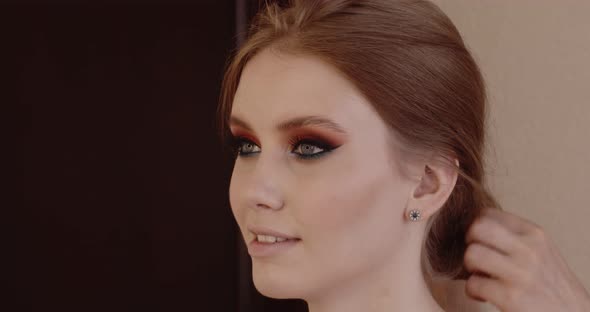 Beautiful girl has her makeup done in a beauty salon.