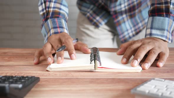 Man's Hand Turning a Pager of a Diary alt