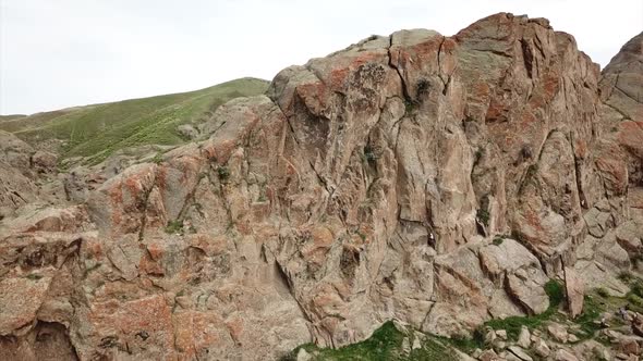 A Man Climbs Up the Cliff alt