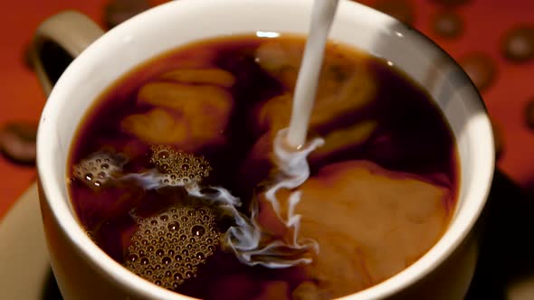 In Cup with Hot Black Coffee Added Many Milk. Closeup alt