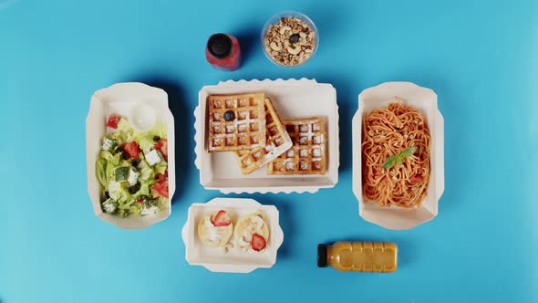Food Delivery Top View Take Away Meals in Disposable Containers on Blue Background alt