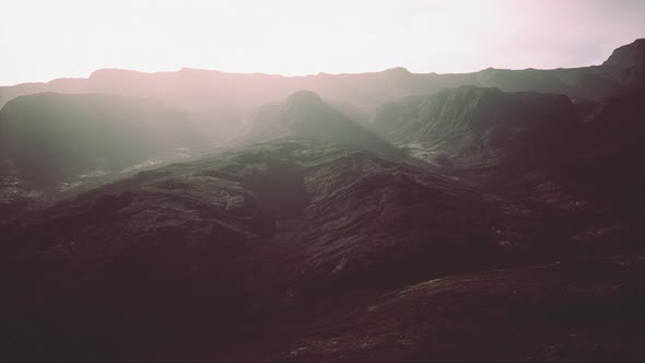 Dark Atmospheric Landscape with High Black Mountain Top in Fog alt