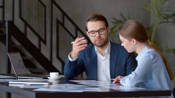 Business colleagues talk project strategy at office alt