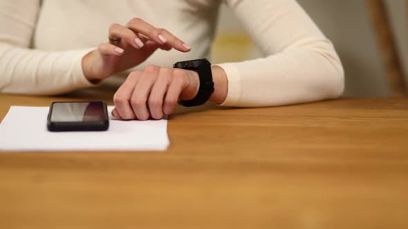 Unrecognizable woman using smartwatch, Freelancer female with smart watch
