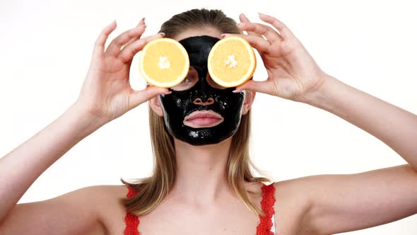 Girl Black Mask on Face Holds Orange Fruits