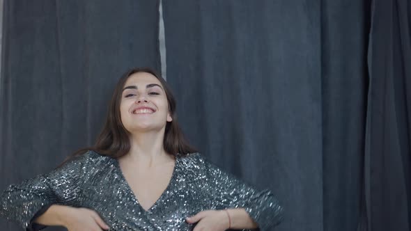 Front View Satisfied Woman Opening Curtains in Dressing Room Looking at Camera Smiling Boasting New alt