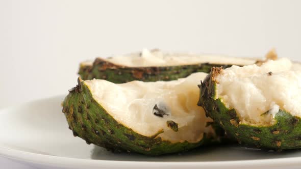 Closeup of Green Sliced Soursop Graviola, Exotic, Tropical Fruit Guanabana on Plate alt