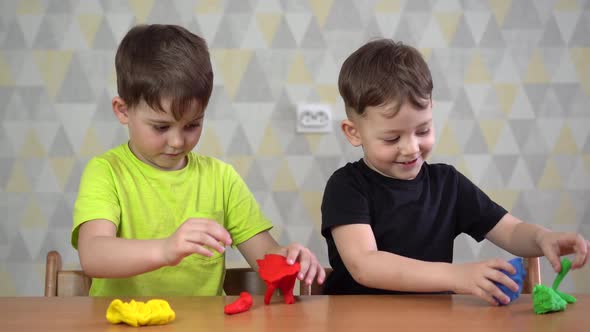 Two Happy Boy Playing with Plasticine.