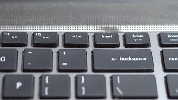 Backspace Button Pressing a Lot of Times on Keyboard Laptop Keyboard Close Up alt