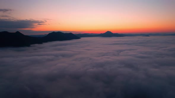 4K Aerial video Beautiful sunrise above dense clouds and fog in the morning, Cinematic drone shot. alt
