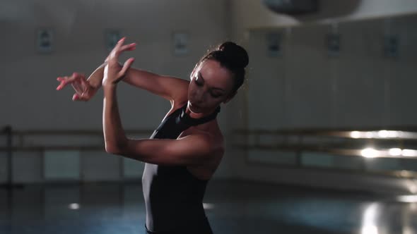 Professional Woman Ballerina in Black Tutu Dancing with Her Hands alt