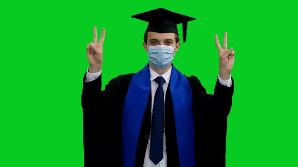 Graduating Student In Protective Mask Doing Hand Gesture With V Sign