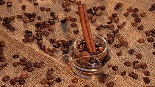 Bottle with Coffee Beans and Cinnamon on Sacking alt