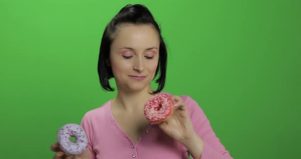 Happy Beautiful Young Girl Posing and Having Fun with Donuts. Chroma Key alt