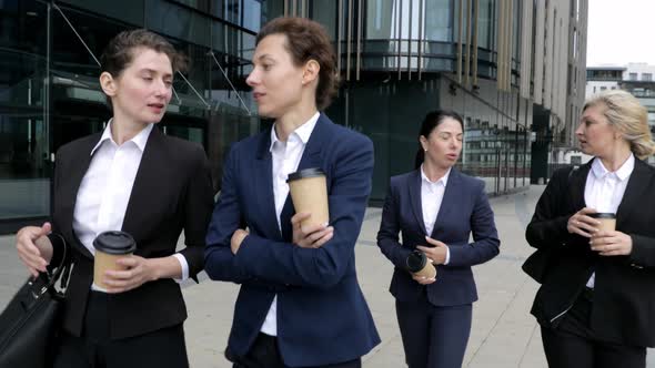 Corporate Female Executives with Coffee Arriving at Modern Building. Confident Businesspersons