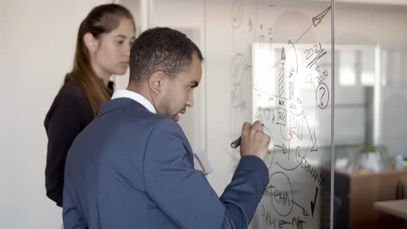 Couple of Business Colleagues Drawing Infographics alt