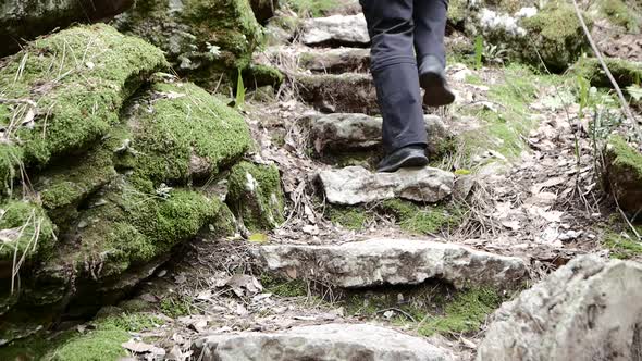 Tourist on Steep Pilgrim Path Along Stone Steps