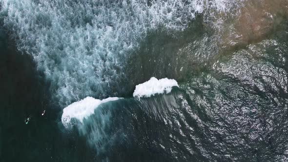 Aerial Drone Footage of Surfers Waiting for the Next Ride on the Big Ocean Wave on Beautiful Aerial