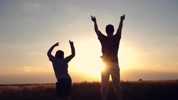 Dad and son playing outside alt