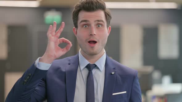 Portrait of Businessman Showing Ok Sign with Finger alt
