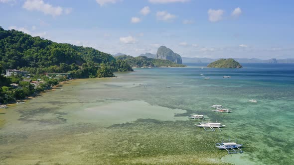 El Nido Palawan Island Philippines Aerial Drone View of Boats Anchored in the Bay with Clear Emerald alt
