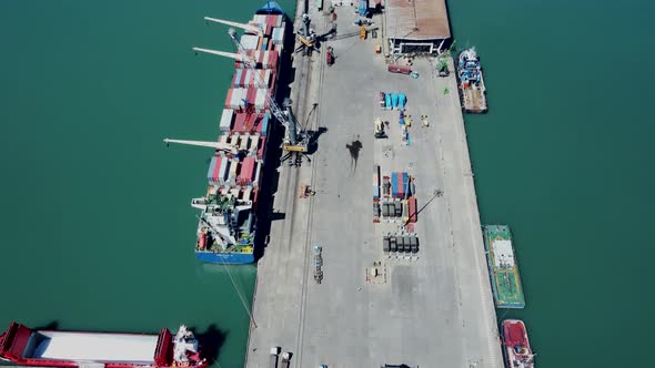 Aerial top view of cargo ship standing in the port alt