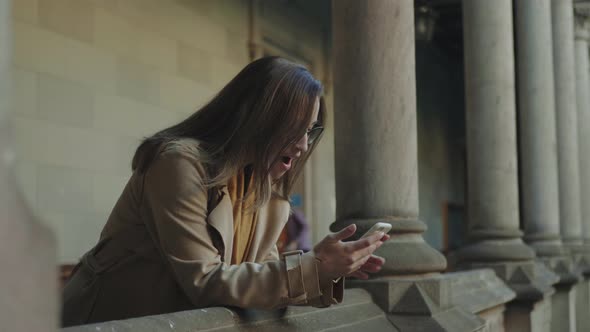 Student Reading Good News on Smartphone alt