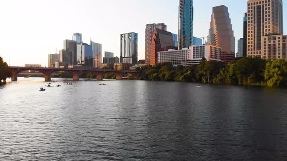Low drone shot of ladybird lake and downtown austin texas. Drone slowly moves towards a group of kay alt