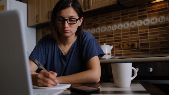 Young Asian Woman Works in the Kitchen alt
